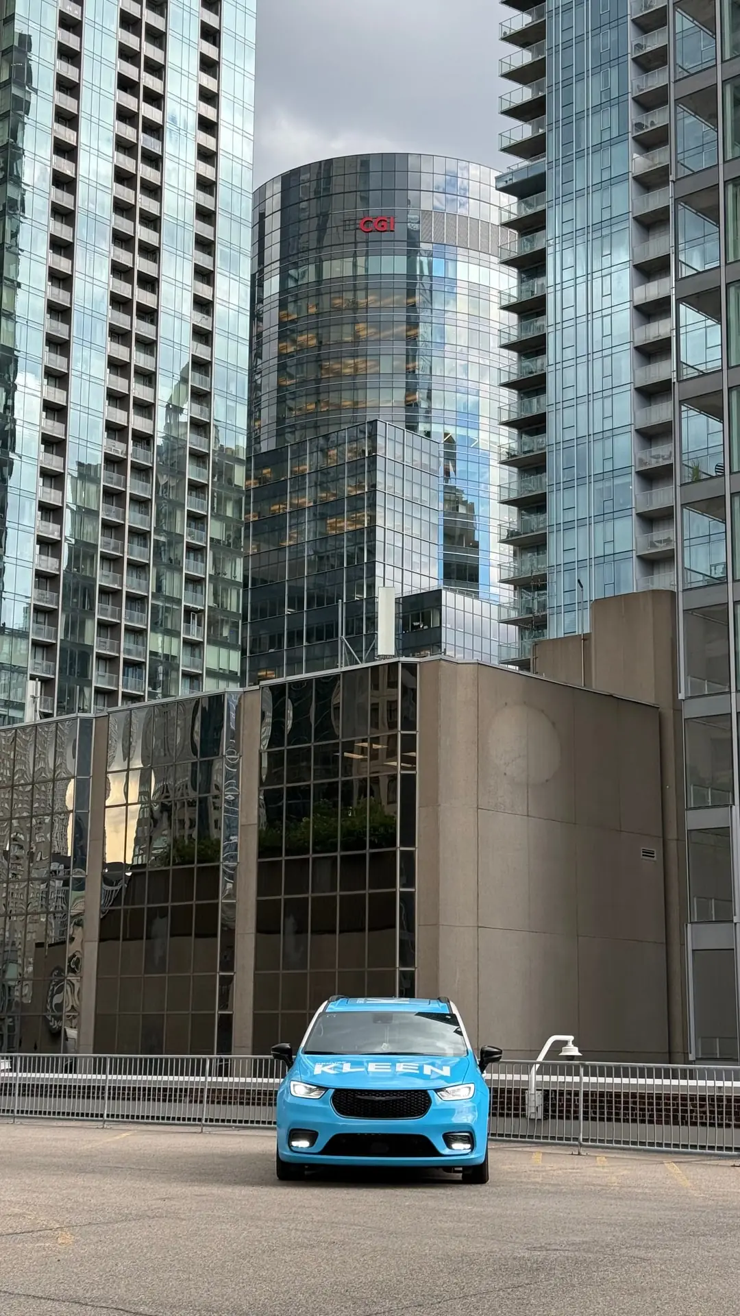 KLEEN minivan facing glass towers