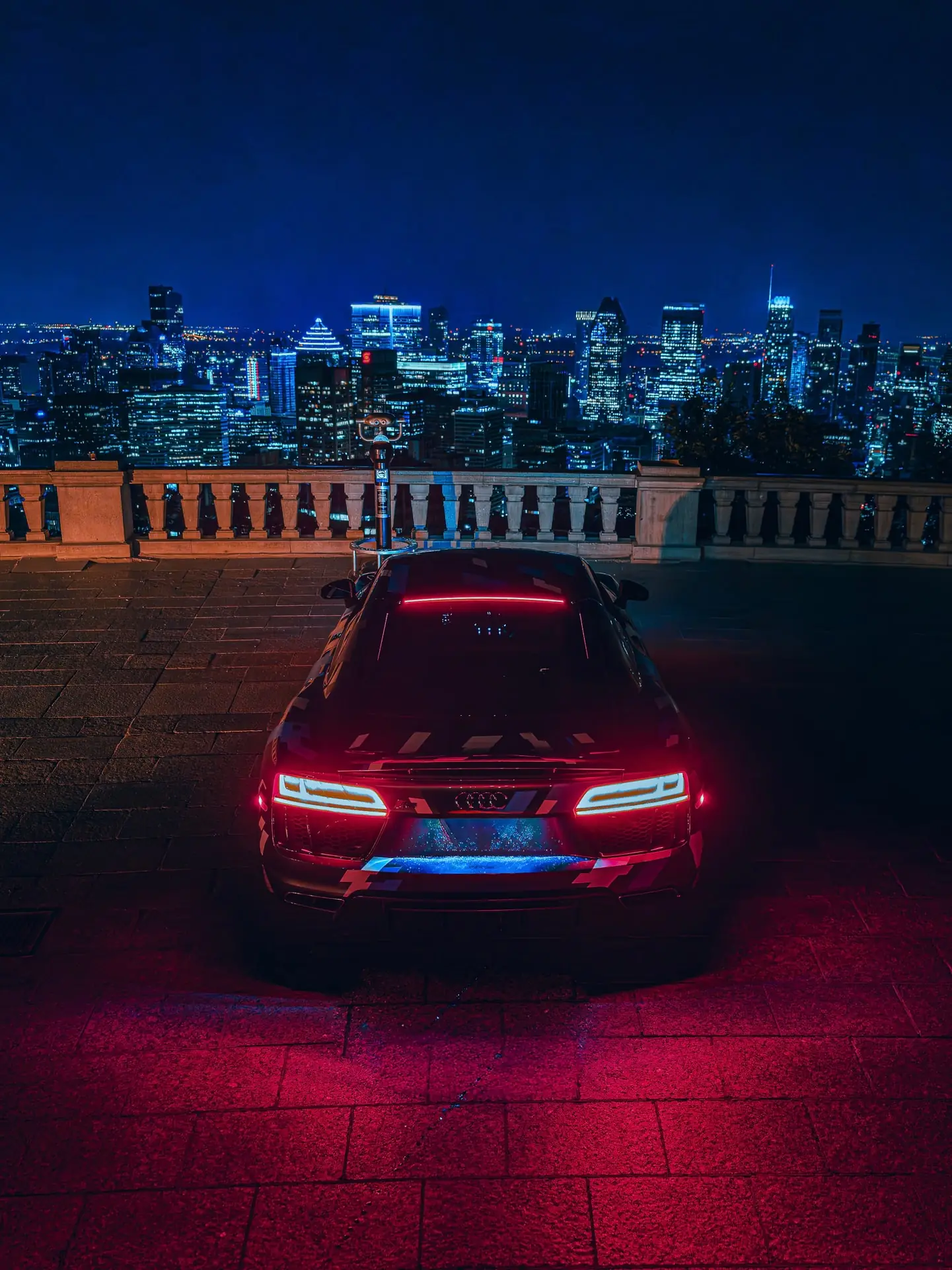 Rear lights of a KLEEN car against the night skyline