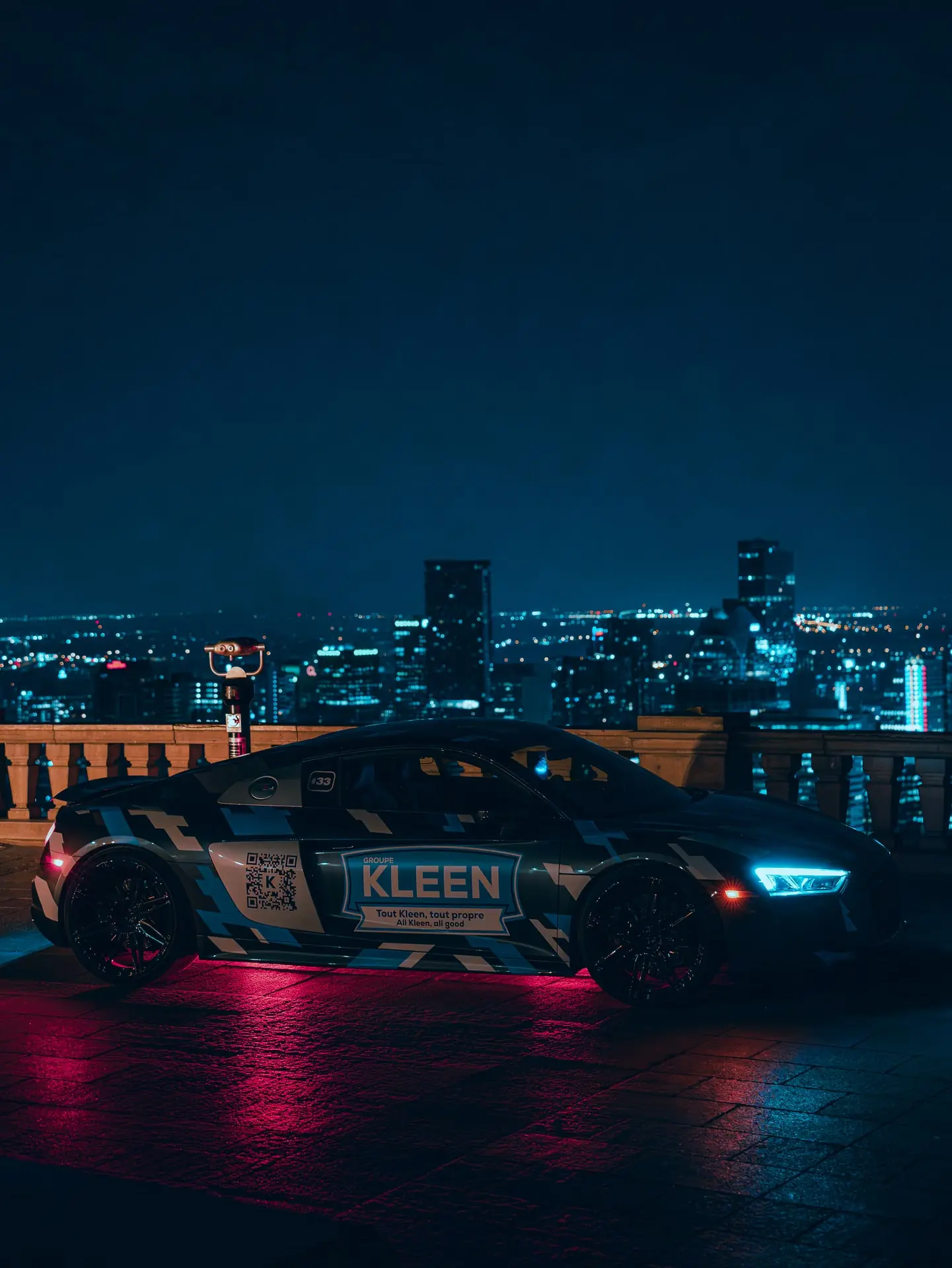 Three-quarter view of a KLEEN car with red reflections on the ground